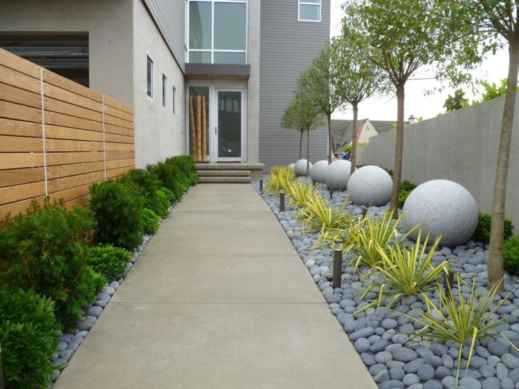 Framträdgårdsdesign-exempel-trottoar-betong-plattor-pollare-ljus-grå-flodstenar-stenbollar