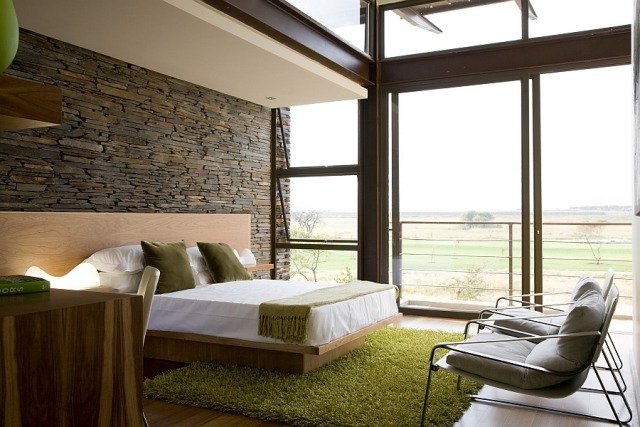 sovrum-vägg-design-natursten-vägg-trä-säng-shaggy-matta-grönt