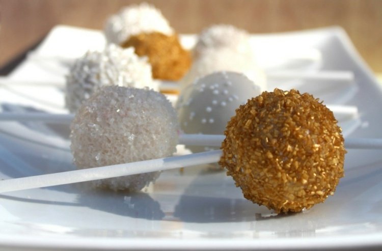 dessert-nyårsafton-tallrik-vit-tårta-poppar-socker-vitt-guld-pärlor-diverse-kokosflingor