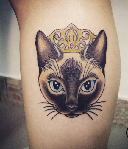 Jumalallinen kissan tatuointi kruunulla