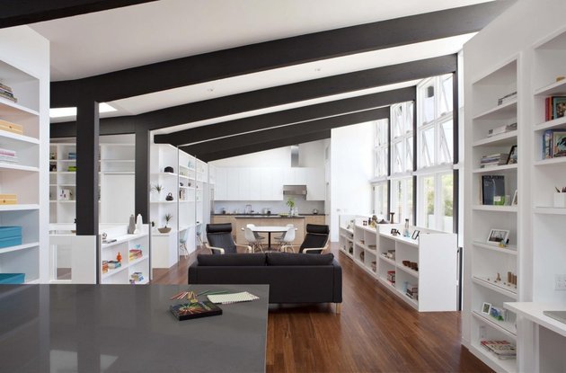 öppna hyllor-vitt-vardagsrum-svart-takbjälkar modern lägenhet design