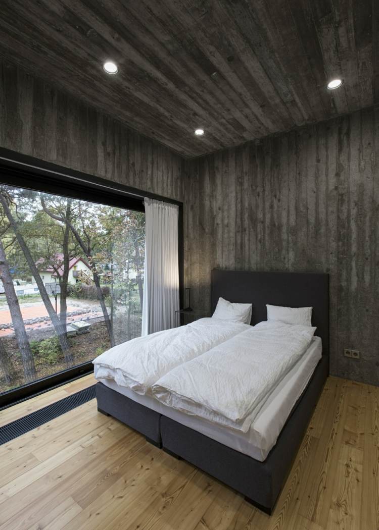 sovrum exempel monokrom betong vägg design grå säng