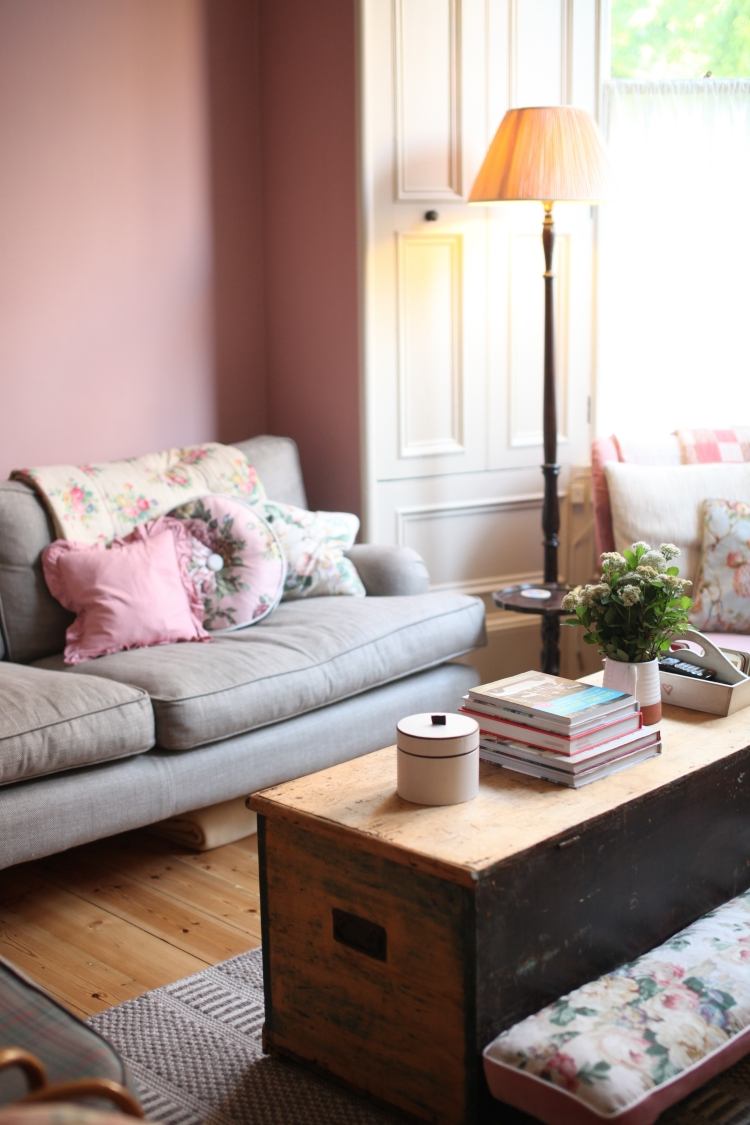 skum rosa-väggfärg-soffa-golvbräda-soffbord-bröst-golvlampa-klädsel
