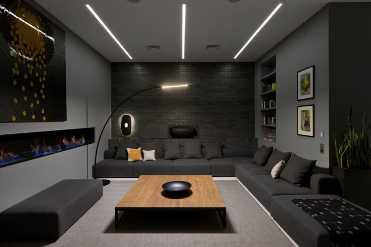 Antracitfärg -modern lägenhet på översta våningen-vardagsrum-soffa-hörn soffa-lampa-klinker tegel