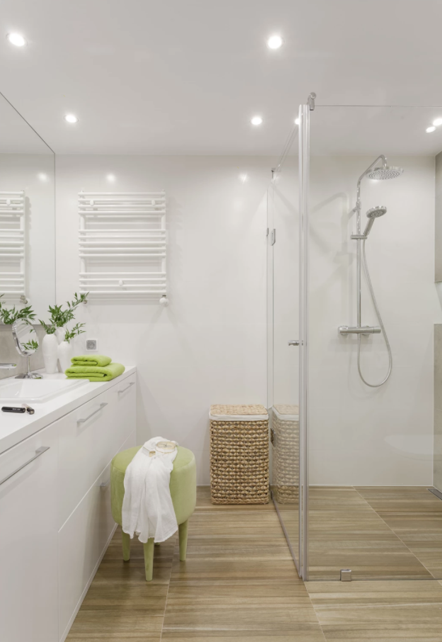 Badrum i vitt och brunt med duschkabin