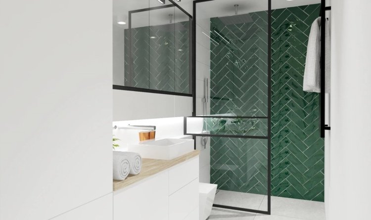 smaragdgröna väggplattor i ett fiskbensmönster i duschkabin