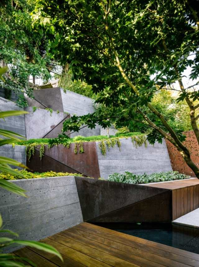 modern trädgård design sluttning betong stödmur metall modern