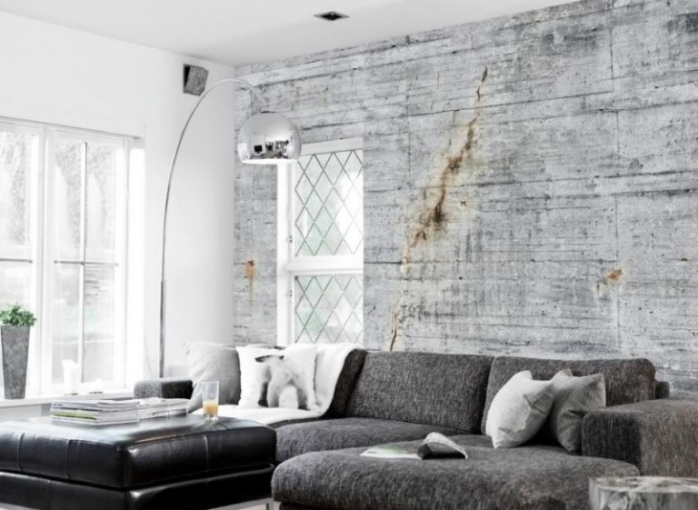 betong-design-modern-vardagsrum-hörn-soffa-grå-fönster-golvlampa-båge-kudde-vägg