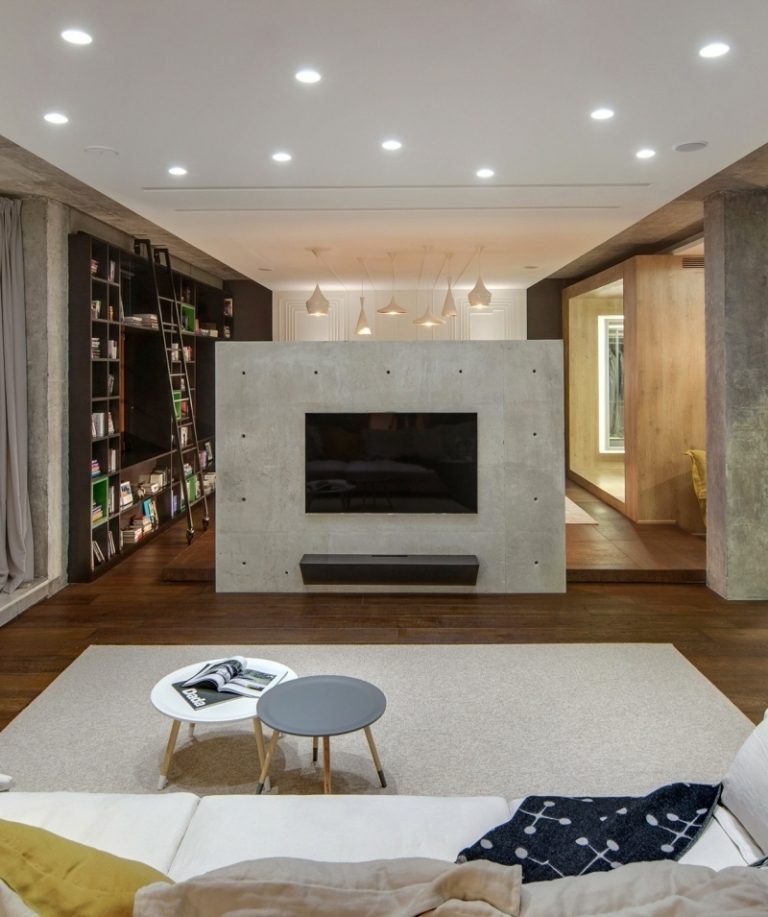 betong-design-modern-vardagsrum-tv-vägg-soffa-sidobord-rund-tv-platser