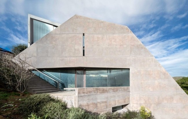 hus bostadsstruktur sluttning grekland betong fasad terrass glasfönster