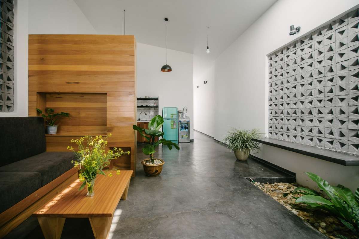 inspirerande design för interiörer med betonggolv, inbyggt kök och skiljevägg av trä