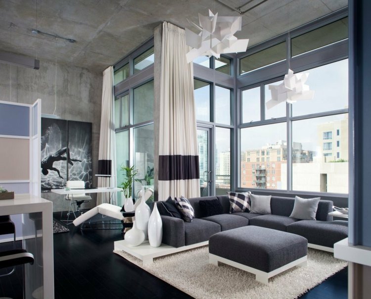 betong-vägg-gör-det-själv-vardagsrum-fönster-fram-hörn soffa-matta-bar-stolar-avkopplande-fåtöljer-hängande-lampor-betongpaneler