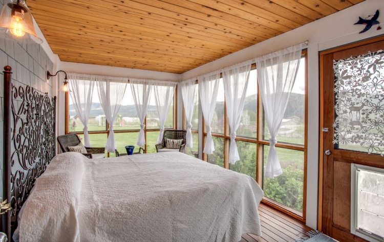 bohemisk stil-sovrum-vitt-trä-tak-metall säng-lekfulla-prydnader-sänggavel-fönster-vy