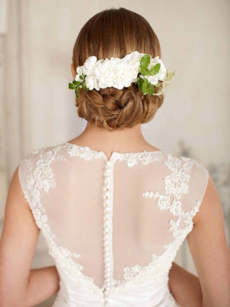 Bröllopsklänning tillbaka tyll spets pärlknappar chignon frisyr med vita blommor