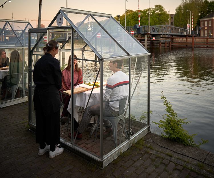Coronaskydd som bygger växthus för restaurang i Amsterdam
