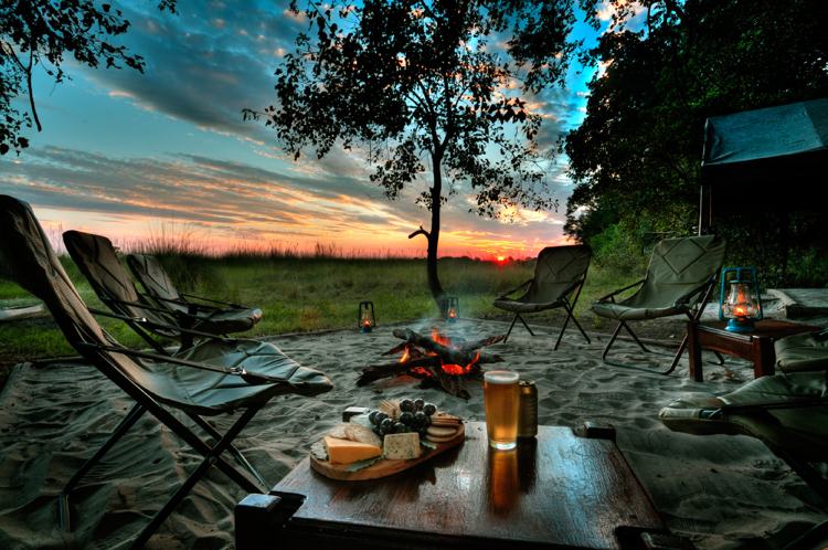 camping-semester-öppen spis-cheeseboard-öl-solnedgång-hopfällbara-stolar