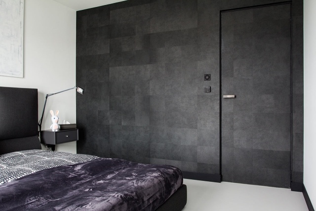 Sovrum modern monokrom platt vägg betong look-mörkgrå-ramlös dörr