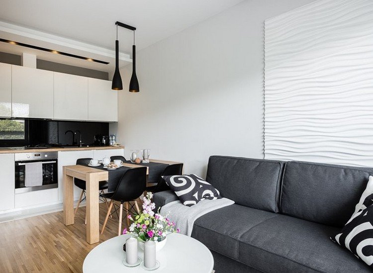 modernt vardagsrum-soffa-grå-vitt-kök-trä-matbord-öppen spis golv