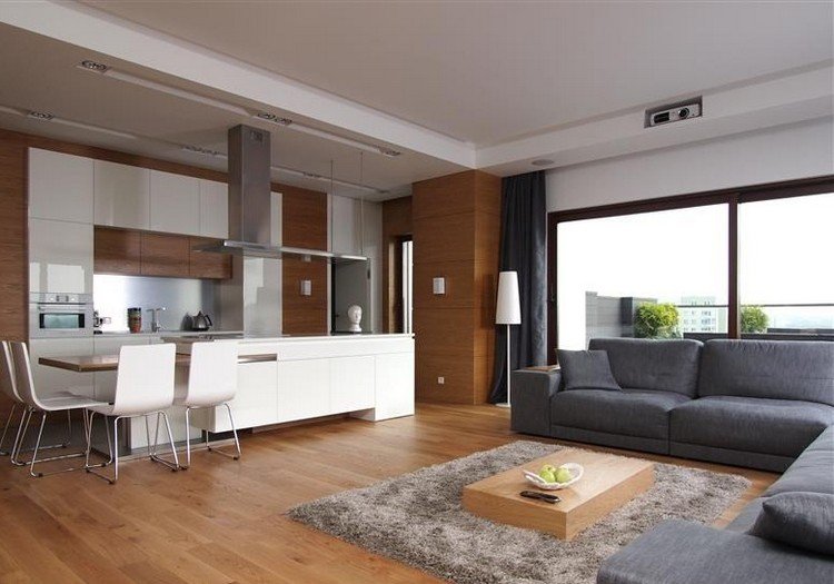 modernt vardagsrum-soffa-grått trägolv-vitt-kök