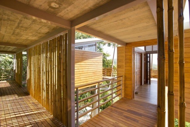 Öppet trähus på pålar med bambu stolpar med havsutsikt