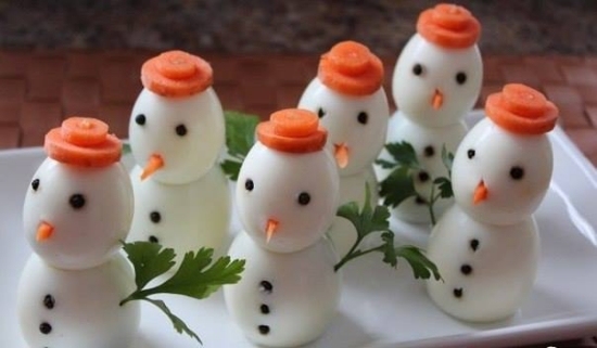 kokta ägg-arrangerade som snögubbe-figurer-med morötter