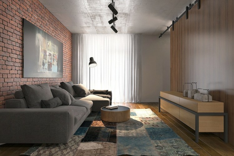 Inredning-studio-lägenhet-tegel-vägg-loft-stil-matta-lapptäcke-grå-soffa