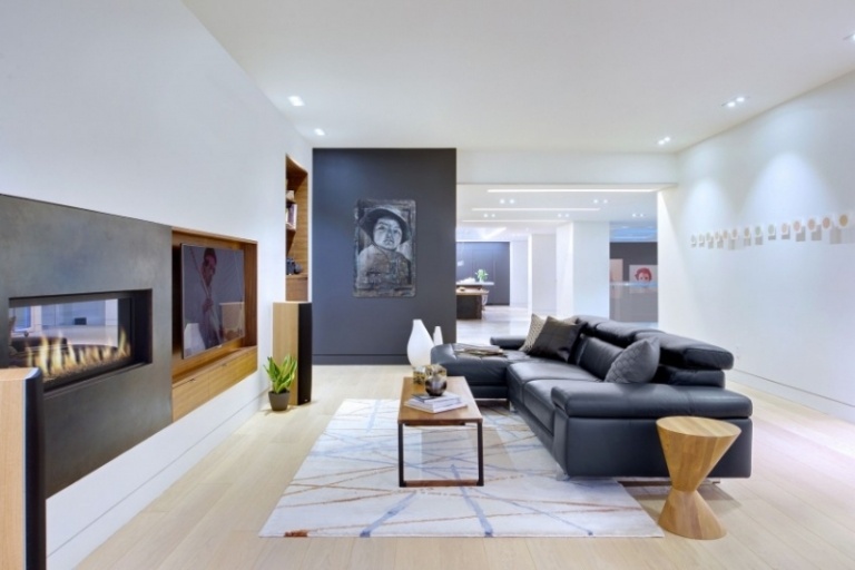 Möbler för vardagsrummet - vit skinnsoffa - svart - öppen spis - tv -vägg - trägolv - ljus bild