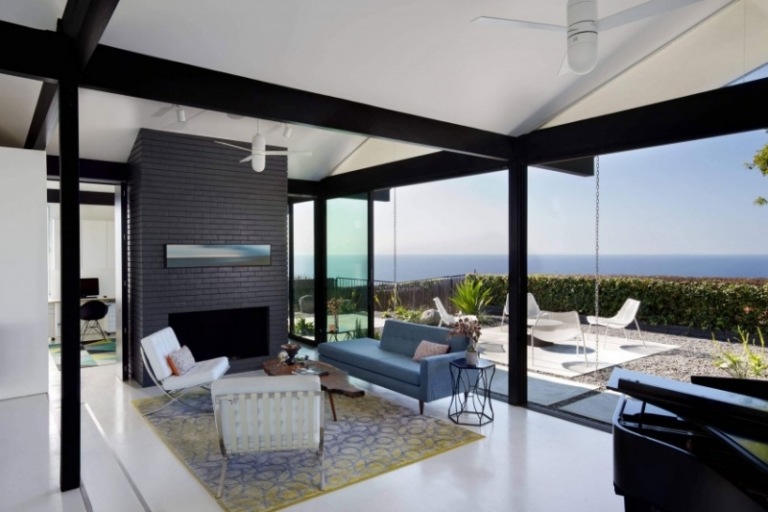 Inredning-vardagsrum-svart-vit-matta-pastell-violett-gul-tegelvägg-antracit-terrass fönster-havsutsikt