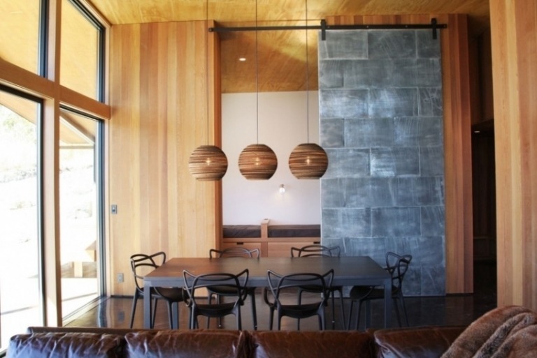 matsal-möbler-matsal-bord-stolar-svart-trä-väggar-terrass-fönster-granit-vägg-läder-soffa