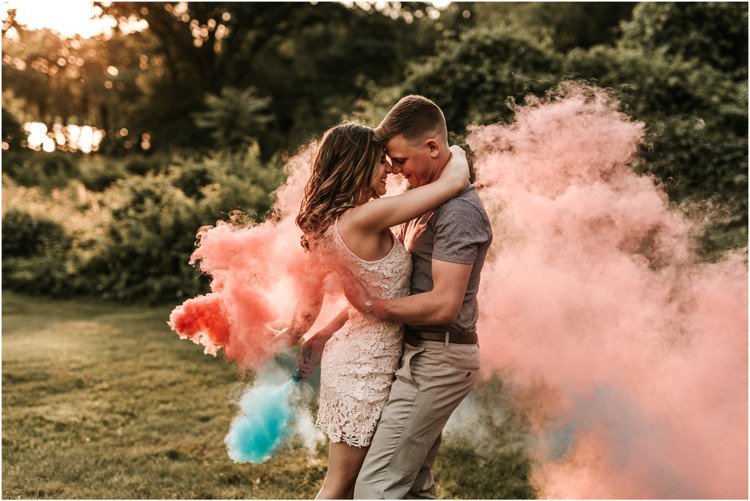 Fotografering med färgbomber som firar förlovningsfestträdgård
