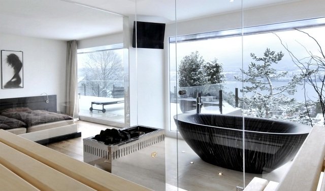 modernt sovrum svart oval badkar glasväggar
