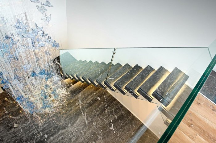 Interna trappor av granit i flytande belysning i glas