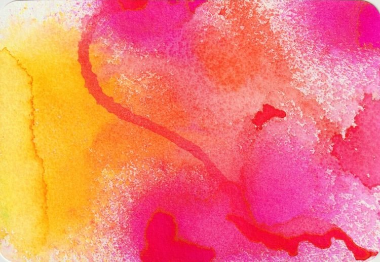 Spraya glada färger från akvarell för en färgglad bild på våren på papper