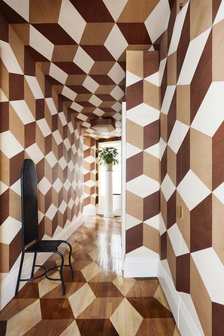 bruna och vita målade tumlade stenar som ett geometriskt väggmönster i korridoren i ett hus med 3d-effekt