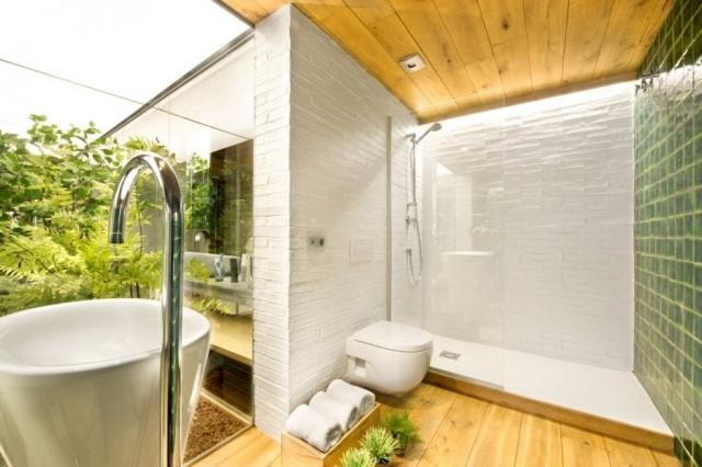 loftlägenhet med inre trädgård badrum glasvägg vita kakel