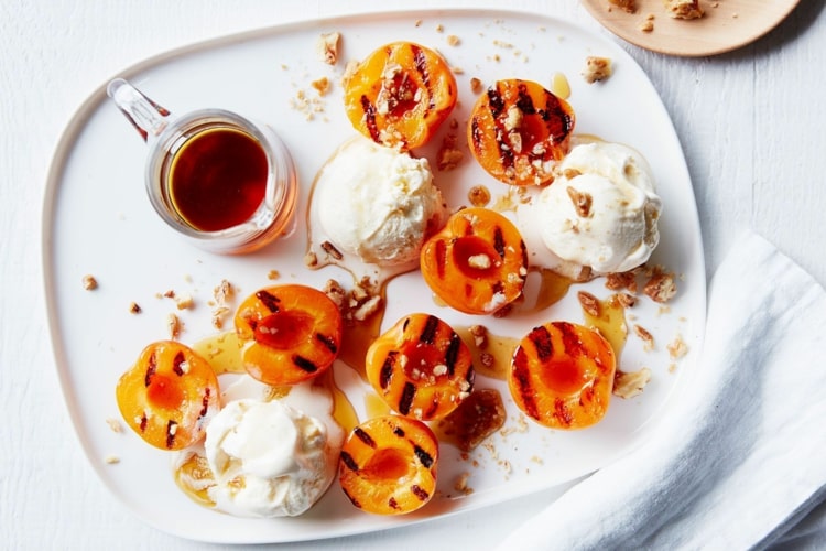 Servera marinerade persikor eller aprikoser med vaniljglass som efterrätt