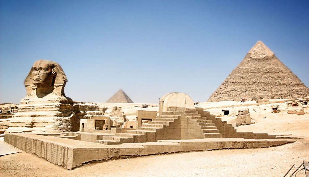 sphynx i förgrunden med egyptiska pyramider i bakgrunden