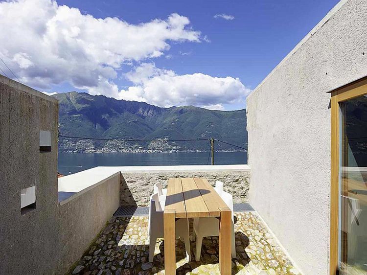 betongsten terrass utsikt sjöhus design matbord