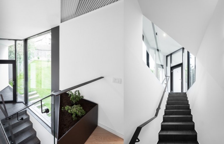 Modern inredning med trappor med skifferplattor och vitmålade väggar
