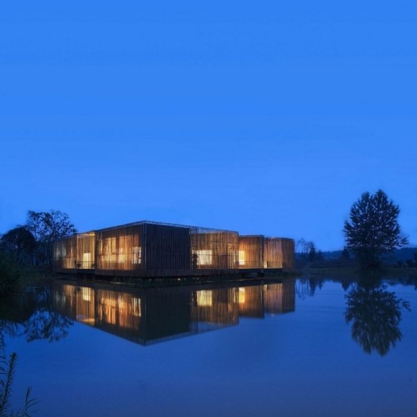 hus med integritetsskärm gjord av bambu i kvällens flod