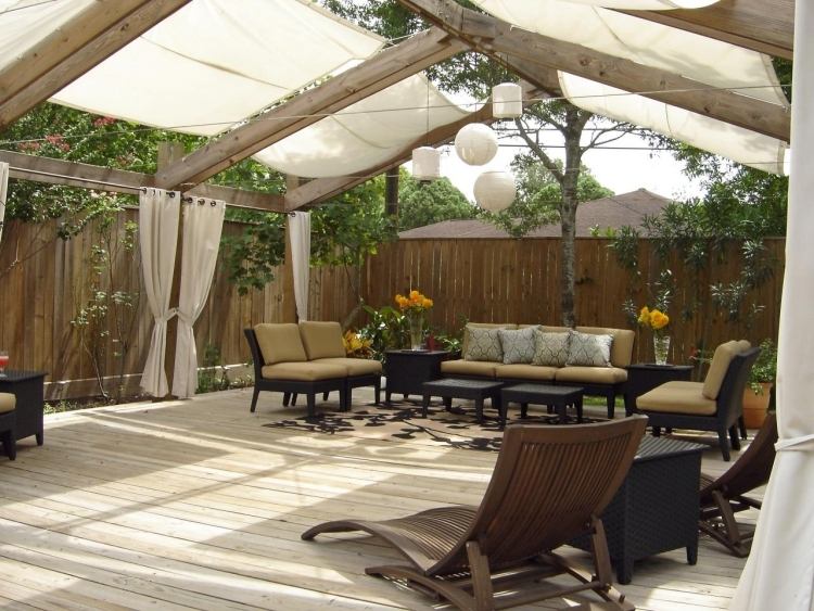 trä-pergola-gardiner-stora-sittplatser-svart-klädsel-tobak-färg-trä golv-hängande lampor-staket-sekretess skärm