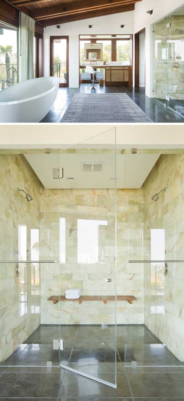 natursten beklädnad inuti badrum glasvägg fristående badkar fönster
