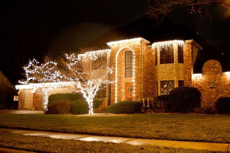 jul-dekoration-utanför-belyst-hus-utomhus-ljus-belysning-trädgård-gräsmatta-träd
