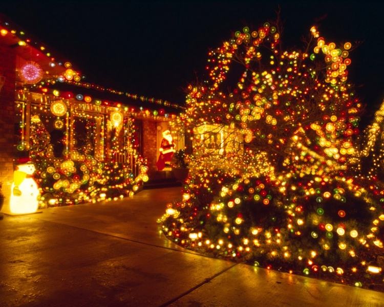 juldekoration-utanför-upplyst-hus-trädgård-färgglada-ljus-buskar-trädgårdsvägar-snögubbe-deco-utomhus