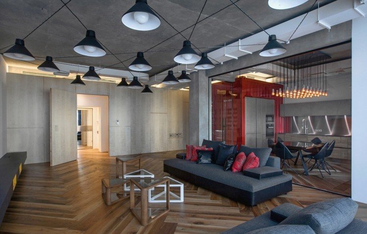 Industriell design möbler -hängande lampor-svart-soffa-grå-soffa-parkettgolv-indirekt-belysning