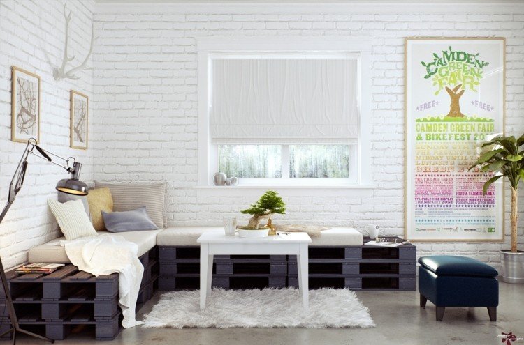 industriell design-möbler-betong-golv-pallar-svart-soffa-tegel vägg-vita-affischer