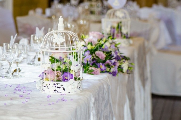 bordsdekoration som ett bröllop dekoration lykta bur lila blommor vit idé