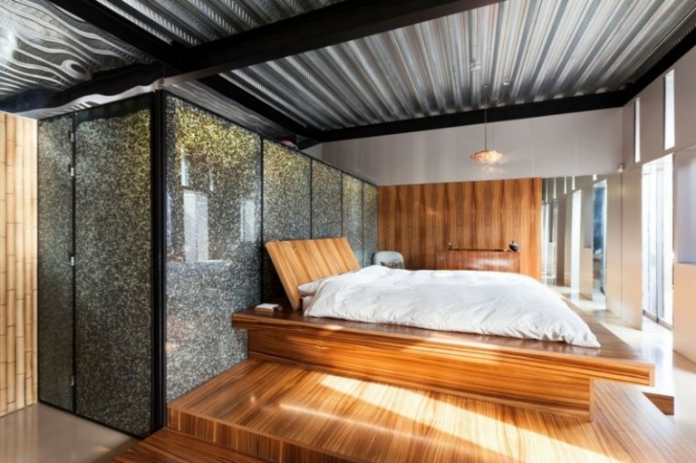 interiör betong aluminium ljus trä sovrum grå vägg design säng