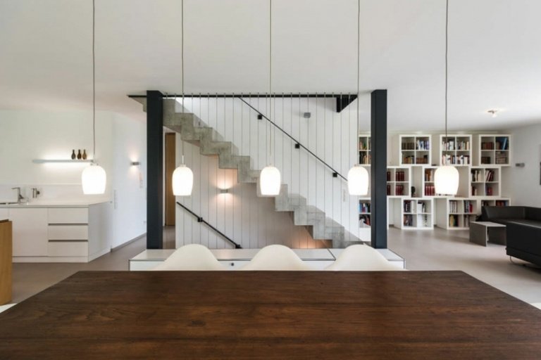 interiör trä betong hängande lampor mörkt matbord trappa område stålbalk