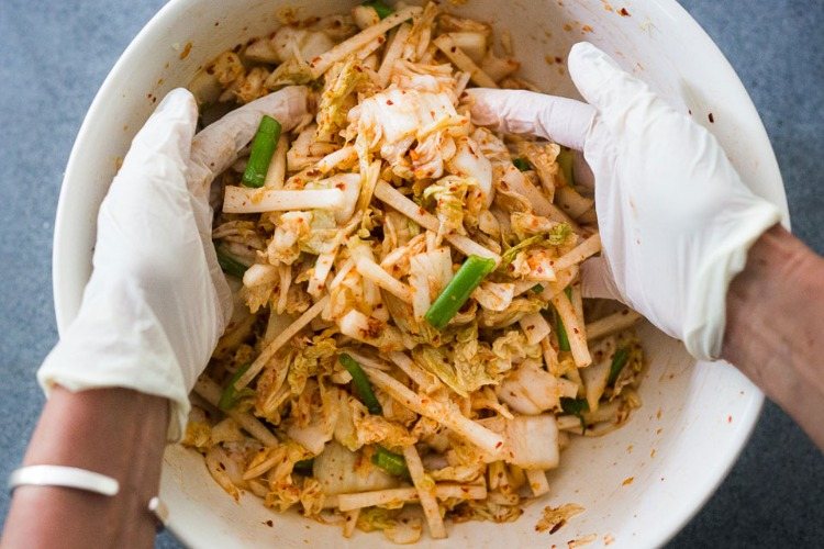Förbereder kimchi med handskar för bättre hygien